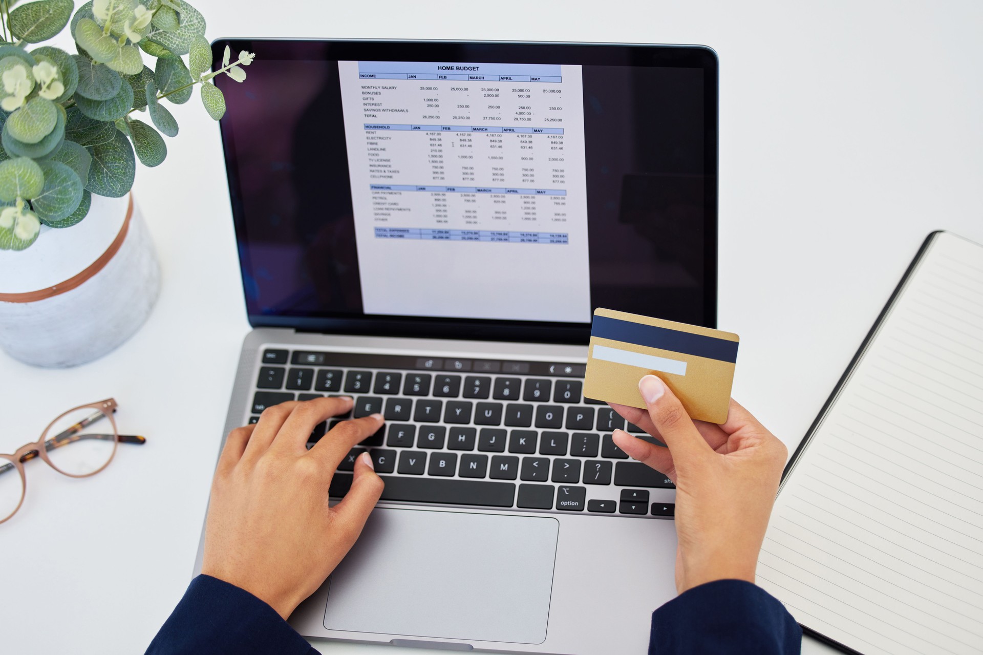 Shot of an unrecognizable person using a laptop to do their budget