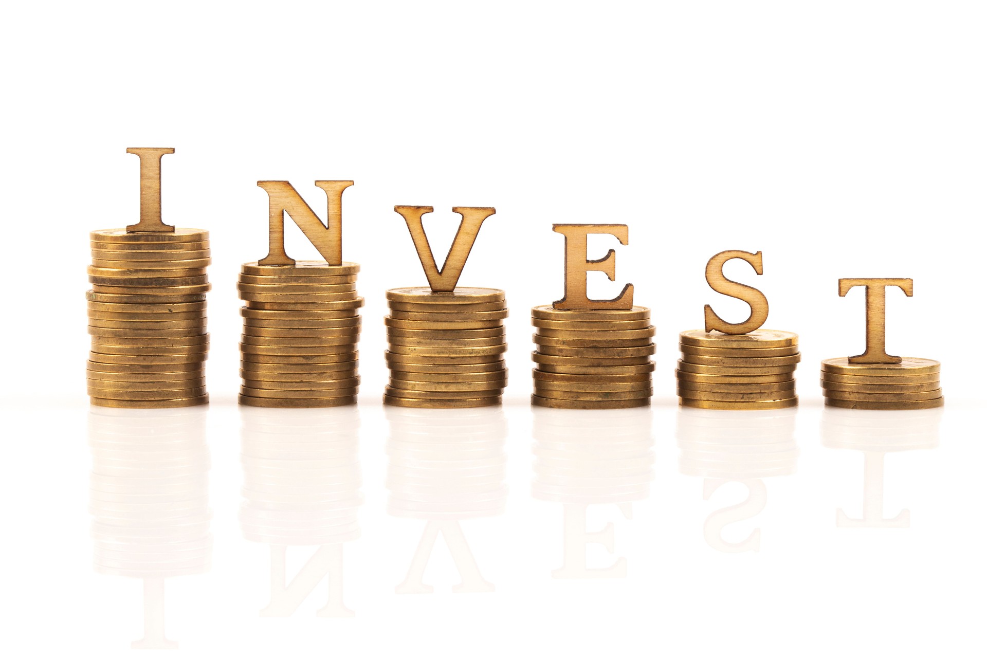 INVEST word on stack of coins