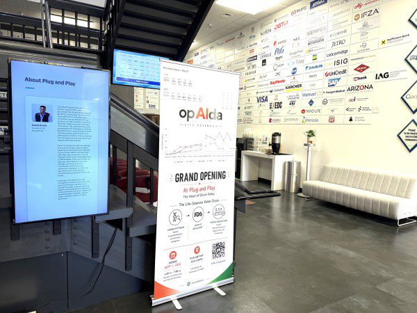 opAIda's “Grand Opening at Plug and Play” banner in the Plug and Play Tech Center lobby.